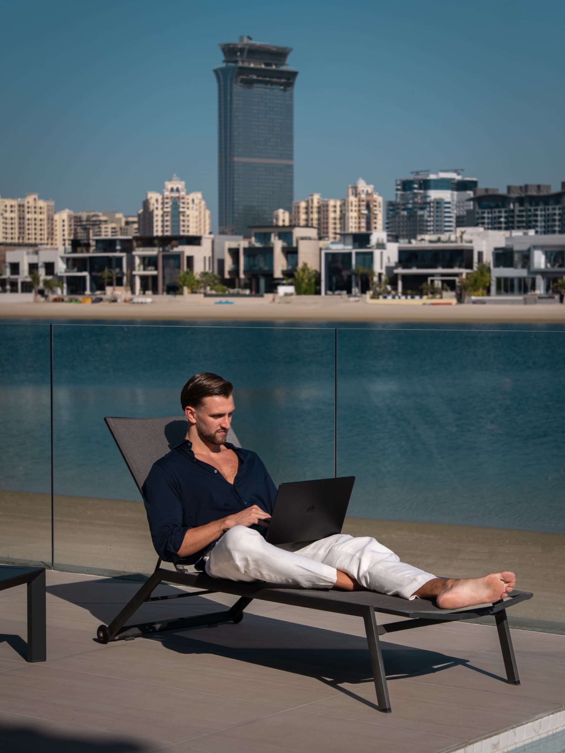 Kilian Kropiunik working poolside at Palm Jumeirah, shot by Lubo Stoev