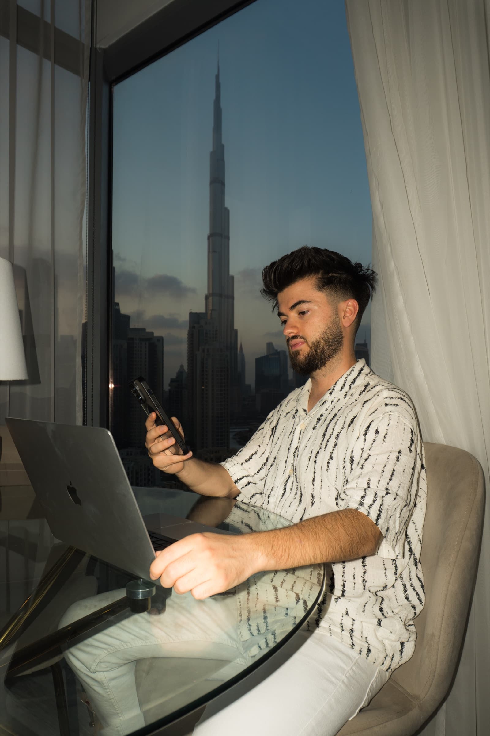 Lubo working with a view of Burj Khalifa in Dubai
